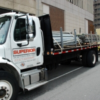 20th & JFK, trucks deliver equipment, overhead protection, Superior Scaffold, 215 743-2200